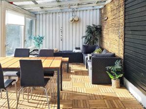 a patio with a table and chairs and a couch at 4 person holiday home in Allingåbro-By Traum in Allingåbro +24 photos