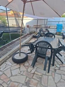 a table and chairs and an umbrella on a patio at Romao in Monsoa +12 photos