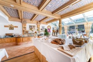 a large kitchen with a table with bread on it at Turmhotel Victoria Davos in Davos
