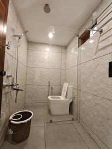 a bathroom with a toilet and a shower at Bella Casa Beach Resort in Varkala +46 photos
