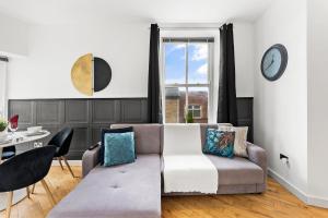 a living room with a couch and a table at 30 percent off! Simple 2 Bed in Central Dewsbury -Sleep 4 in Dewsbury