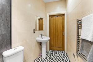a bathroom with a sink and a toilet and a mirror at 30 percent off! Simple 2 Bed in Central Dewsbury -Sleep 4 in Dewsbury
