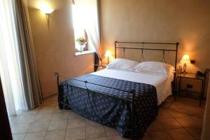 Postel nebo postele na pokoji v ubytování Hotel Le Botti
