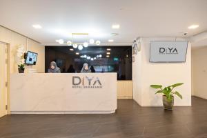 a reception area of a dermatologists office with two people at Diya Hotel Bangkok in Amphoe Phra Khanong