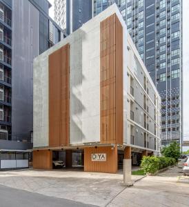 a building in a city with tall buildings at Diya Hotel Bangkok in Amphoe Phra Khanong