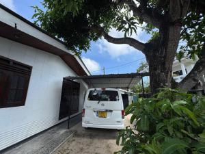 a white van parked in front of a house at Vintage Voyage Villa in Negombo