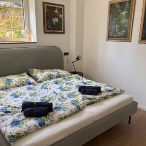 a bed with two pillows on top of it at Yellow Rose in Balatongyörök