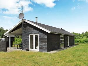 a small house in a field with a satellite at 6 person holiday home in Hals-By Traum in Hals