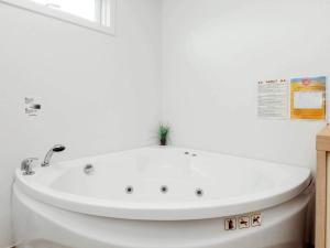 a white bath tub with a plant on top of it at 6 person holiday home in Hals-By Traum in Hals +16 photos