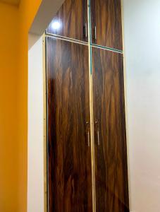 a wooden cabinet with a glass door in a room at Well furnished Room in Apartment in Rahimyar Khan