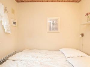 a bedroom with a bed and a picture on the wall at 4 person holiday home in Ærøskøbing in Ærøskøbing