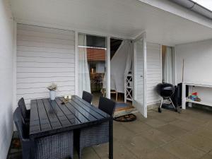 a patio with a table and chairs on a porch at 4 person holiday home in Ærøskøbing in Ærøskøbing