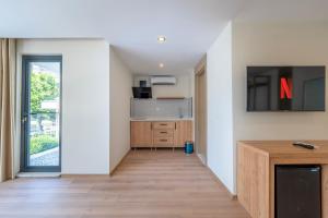 a kitchen with white walls and a sliding glass door at Bun'ca Rooms in Antalya +25 photos