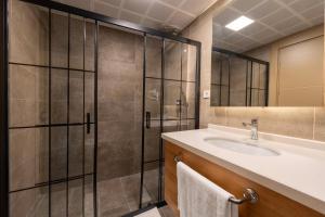 a bathroom with a sink and a shower at Bun'ca Rooms in Antalya