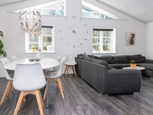 a living room with a couch and a table at 4 star holiday home in Ringkøbing in Ringkøbing