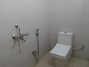 a bathroom with a toilet and a shower at New Hotel White Palace in kolkata