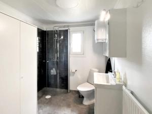 a white bathroom with a toilet and a shower at 5 person holiday home in Tenhult Jönköping in Hult