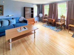 a living room with a blue couch and a table at 5 person holiday home in Tenhult Jönköping in Hult +31 photos