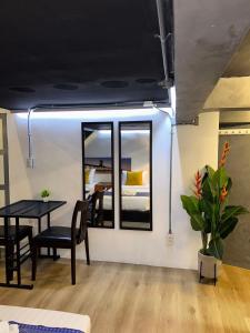 a room with a table and chairs and a bedroom at Usman Halal Home in Bangkok