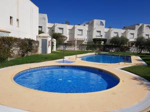a large pool in front of a building at Casa Caprese in Vera