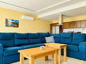 a blue couch in a living room with a table at Danny House in Nadur +43 photos