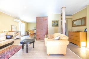 a living room with two couches and a table at Sireli Holiday Home in Pärnu