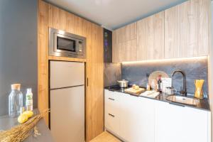 a kitchen with a white refrigerator and a microwave at Be Casa - Valdebebas in Madrid
