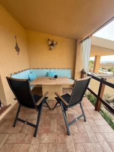 a dining room with a table and two chairs at Villa Oliva in Costa Paradiso