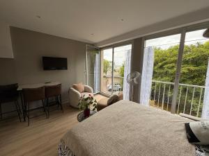a bedroom with a bed and a view of a balcony at Escapade à la mer studio in Dinard