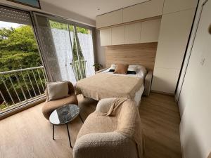 a bedroom with two beds and a window at Escapade à la mer studio in Dinard