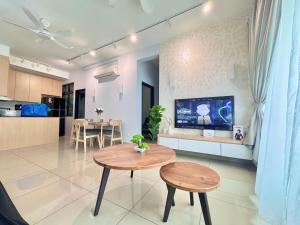 a living room with two tables and a tv at D'Chill Suite【Austin Regency】Netflix in Johor Bahru