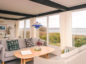a living room with a couch and a table at 6 person holiday home in Børkop-By Traum in Børkop +19 photos