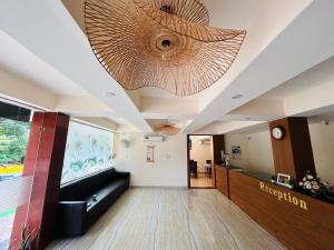 a lobby with a large chandelier on the ceiling at The ZEN INN , Pure veg hotel in Bodhgaya in Bodh Gaya