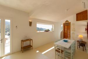 a dining room with a table and chairs and a window at Villa Tuna in Torre delle Stelle