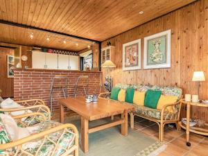 a living room with a couch and a table at 8 person holiday home in Svendborg in Svendborg