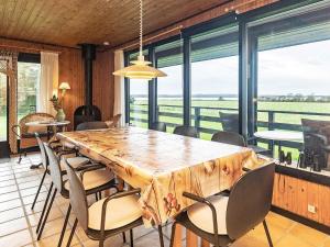 a dining room with a large wooden table and chairs at 8 person holiday home in Svendborg in Svendborg