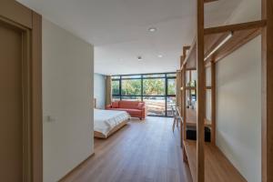 a bedroom with a bed and a living room at Bun'ca Rooms in Antalya