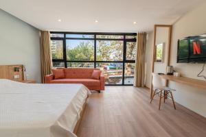 a bedroom with a bed and a chair and a couch at Bun'ca Rooms in Antalya
