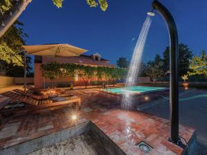a swimming pool with a fountain in a backyard at Holiday Home in Zemunik Donji with Pool in Donji Zemunik