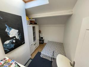 a small room with a bed and a painting on the wall at Room in city Nice in Nice