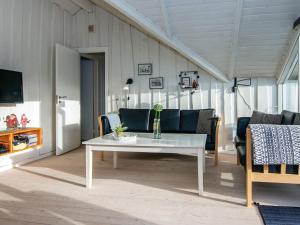 ein Wohnzimmer mit einem weißen Tisch und einer Couch in der Unterkunft 8 person holiday home in Hejls-By Traum in Hejls