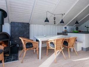 eine Küche mit Tisch und Stühlen und einem Kamin in der Unterkunft 8 person holiday home in Hejls-By Traum in Hejls + 22 Fotos