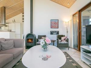 a living room with a table and a fireplace at Panoramic Seaside Retreat - By Traum Ferienwohnungen in Thorsminde