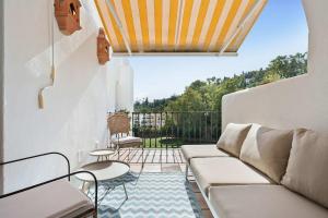 a living room with a couch and a table at Beautiful Golfside Hideaway in Benahavís