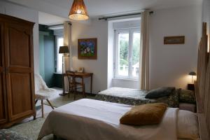 a bedroom with two beds and a window at L'Estive du Claux in Le Claux