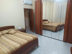 a bedroom with two beds and a large mirror at Giulianova vacanze in Giulianova