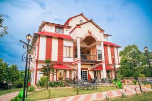 a large house with red and white stripes at Ekata Sutra in Agartala +6 photos