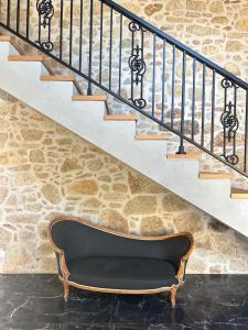 a bench sitting under a stair case at Paços de Douro - Bedroom 5 Relaxation & Space in Romariz