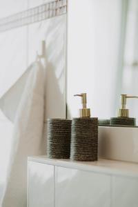 a shelf with two bottles ofodorizers on it in a bathroom at Bauhaus Museum Apartment in Dessau +27 photos