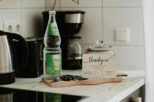 a bottle of water and a jar on a counter at Bauhaus Museum Apartment in Dessau